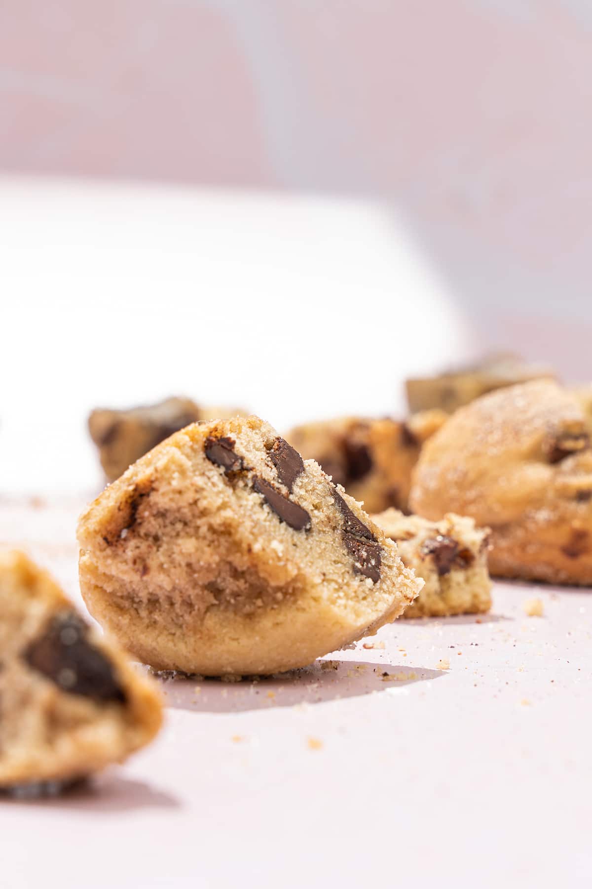 A pile of Wandel's Original cookie bites with a pink background